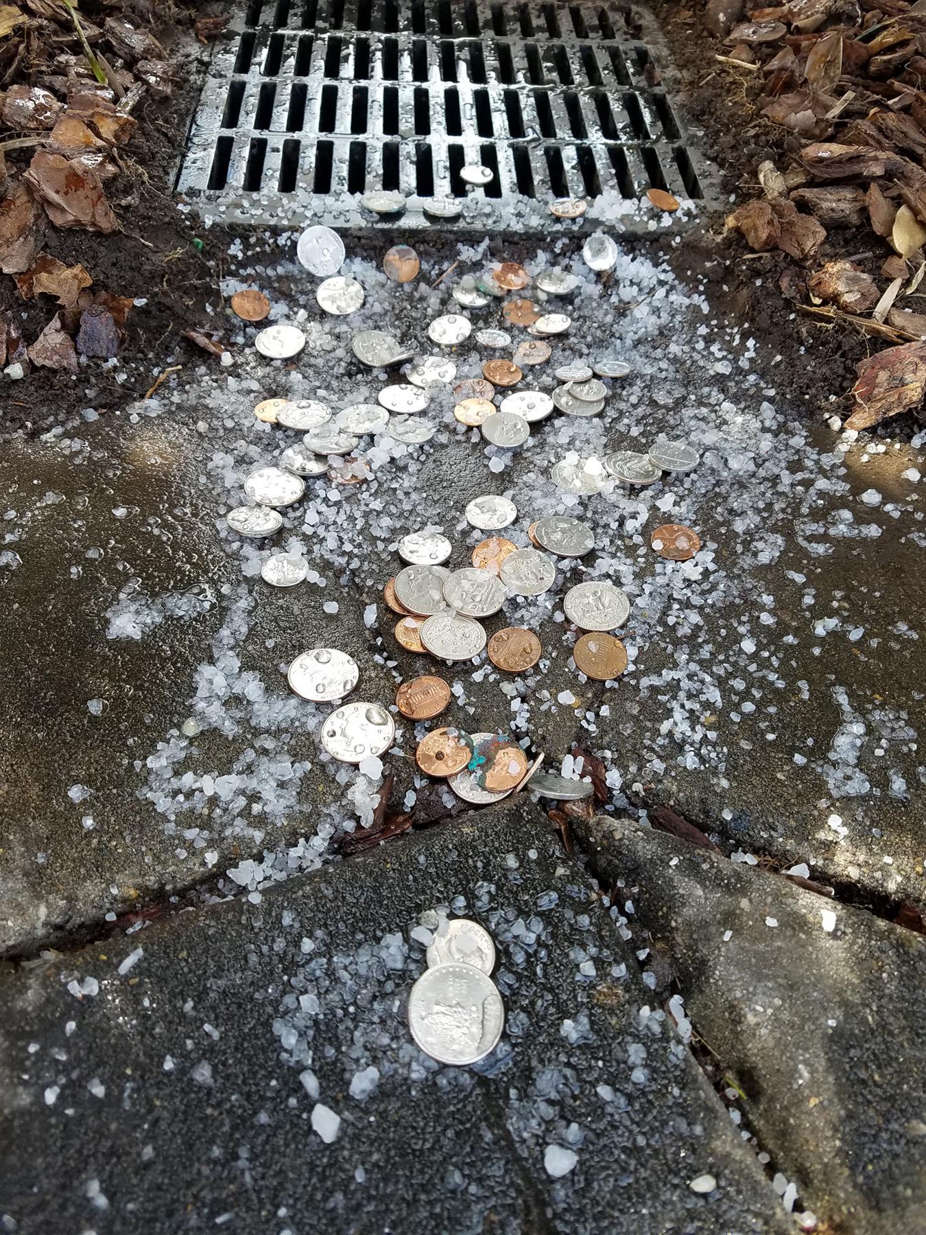 Coins and salt are being washed toward the storm drain.