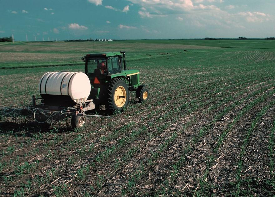 Farmer Spraying Nutrient on Field