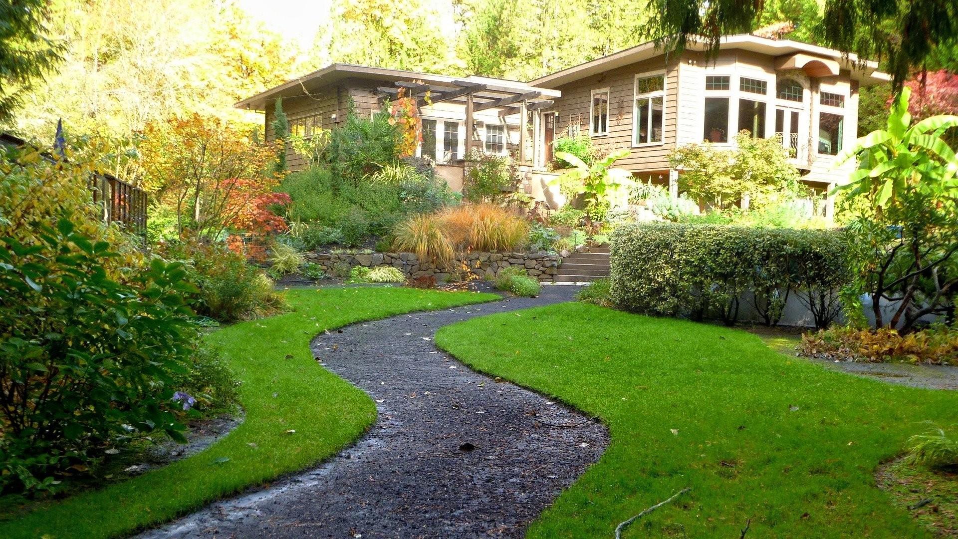 house with a small front lawn and gardens