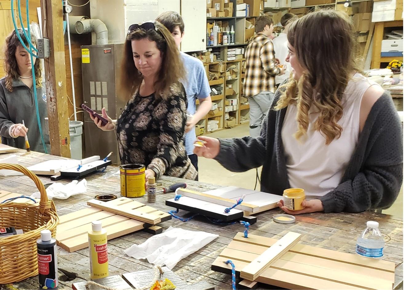  Three Women at a Workbench - 4-H volunteers working with youth to showcase careers during career days and workshops.