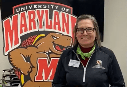 Horticulturist in front of Maryland Terrapin sign